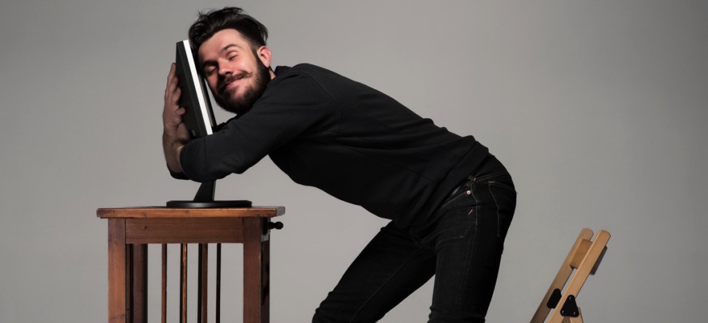 Man hugging his computer monitor