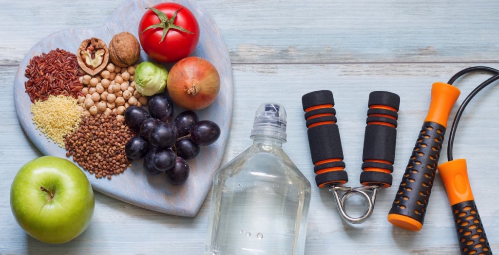 Healthy food, dumbbells and bottle of water